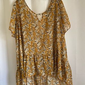 Mustard floral hi-lo top with ruffled bottom.